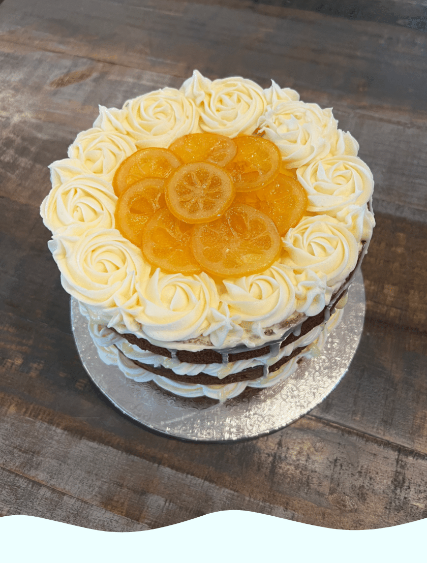 a gluten free cake toped with whipped cream and fresh fruit