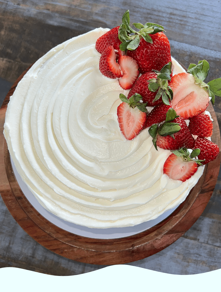 A gluten free white cake topped with strawberries